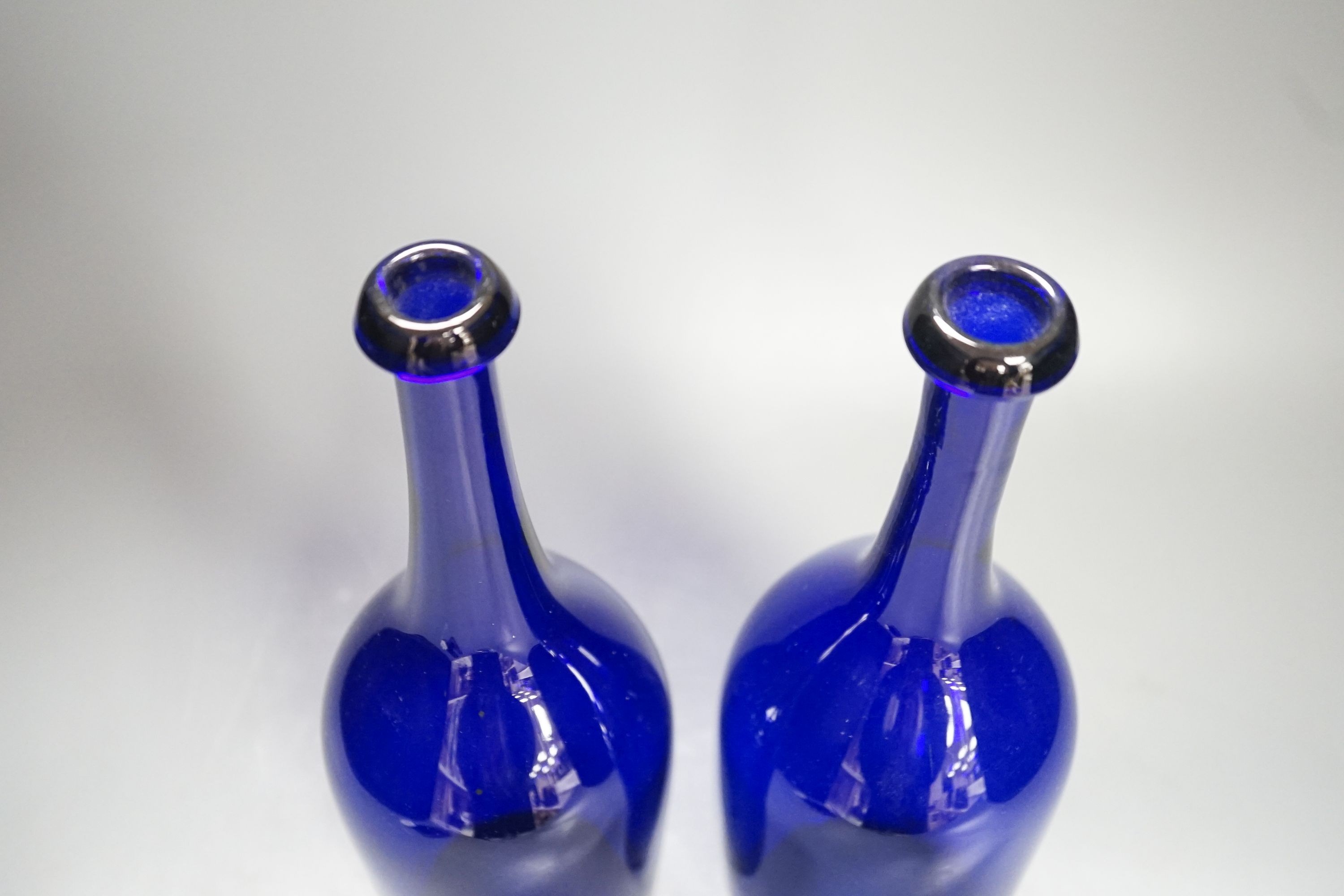 A pair of 19th century blue glass bottles 29cm